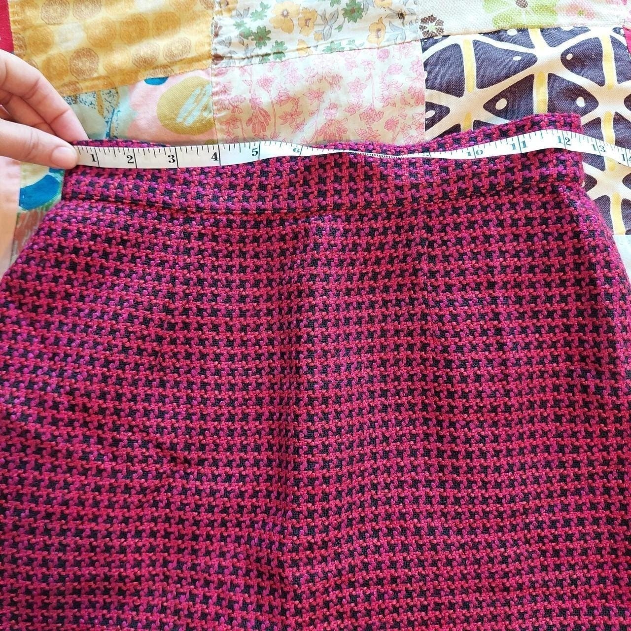 Vintage red, pink, and black houndstooth skirt with zipper and button closure.