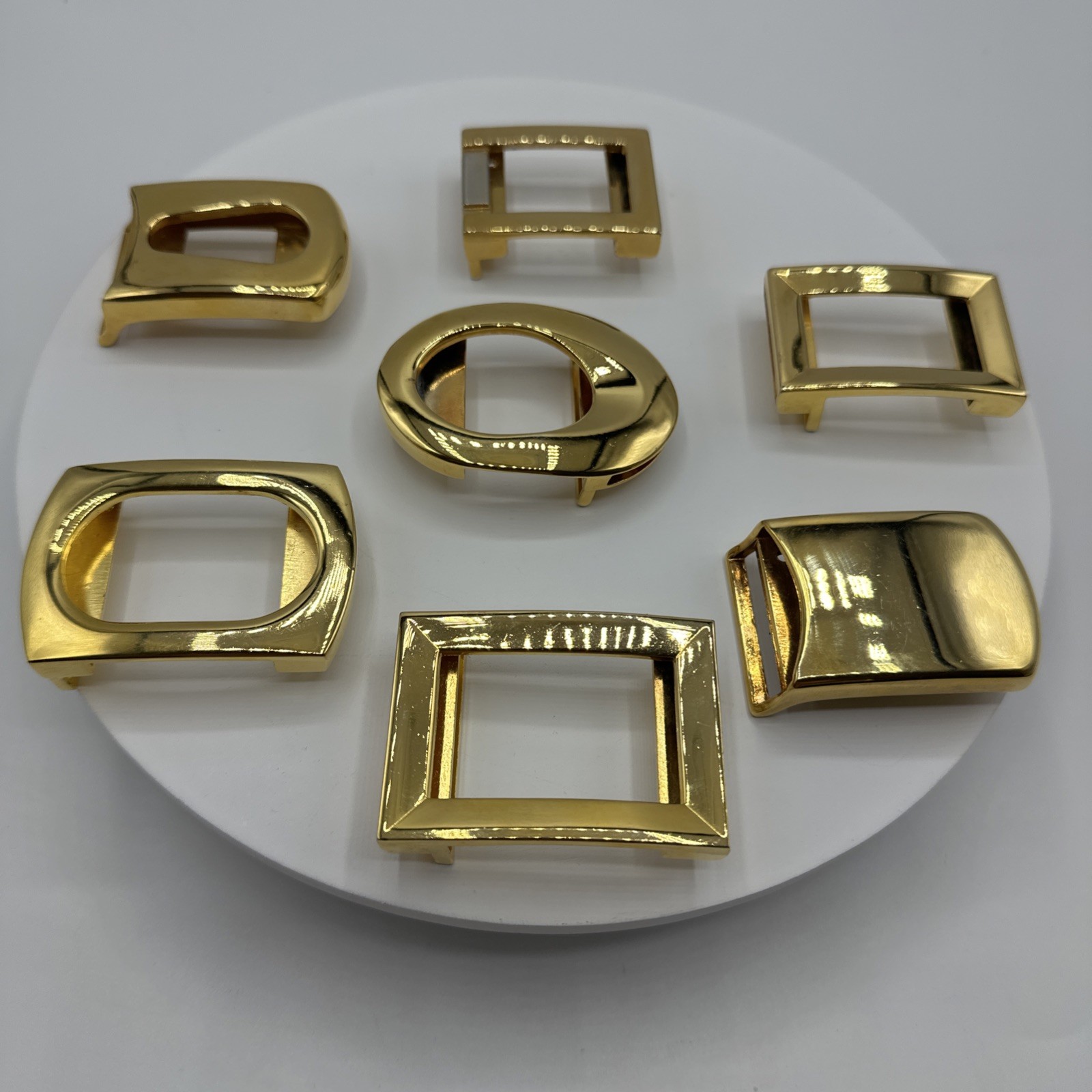 Seven vtg gold toned unisex buckles. Made in Spain and Italy. Stamped. See pics.