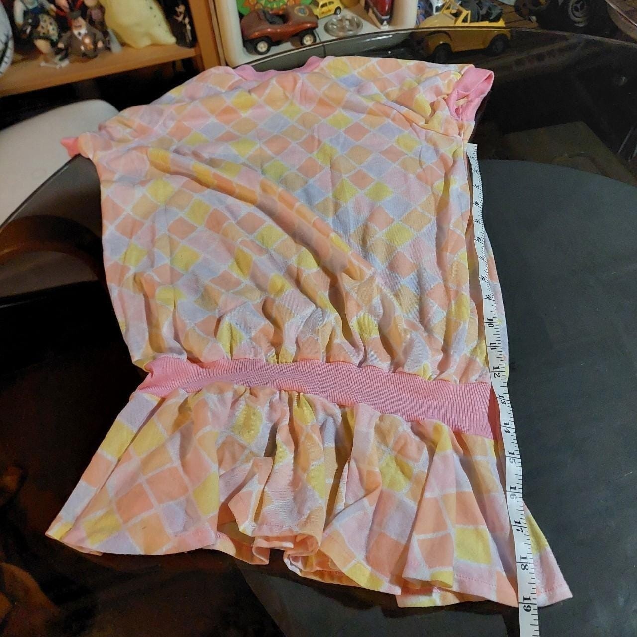 Vintagecpastel pink, purple, yellow, and orange diamond top with a ruffle hem.