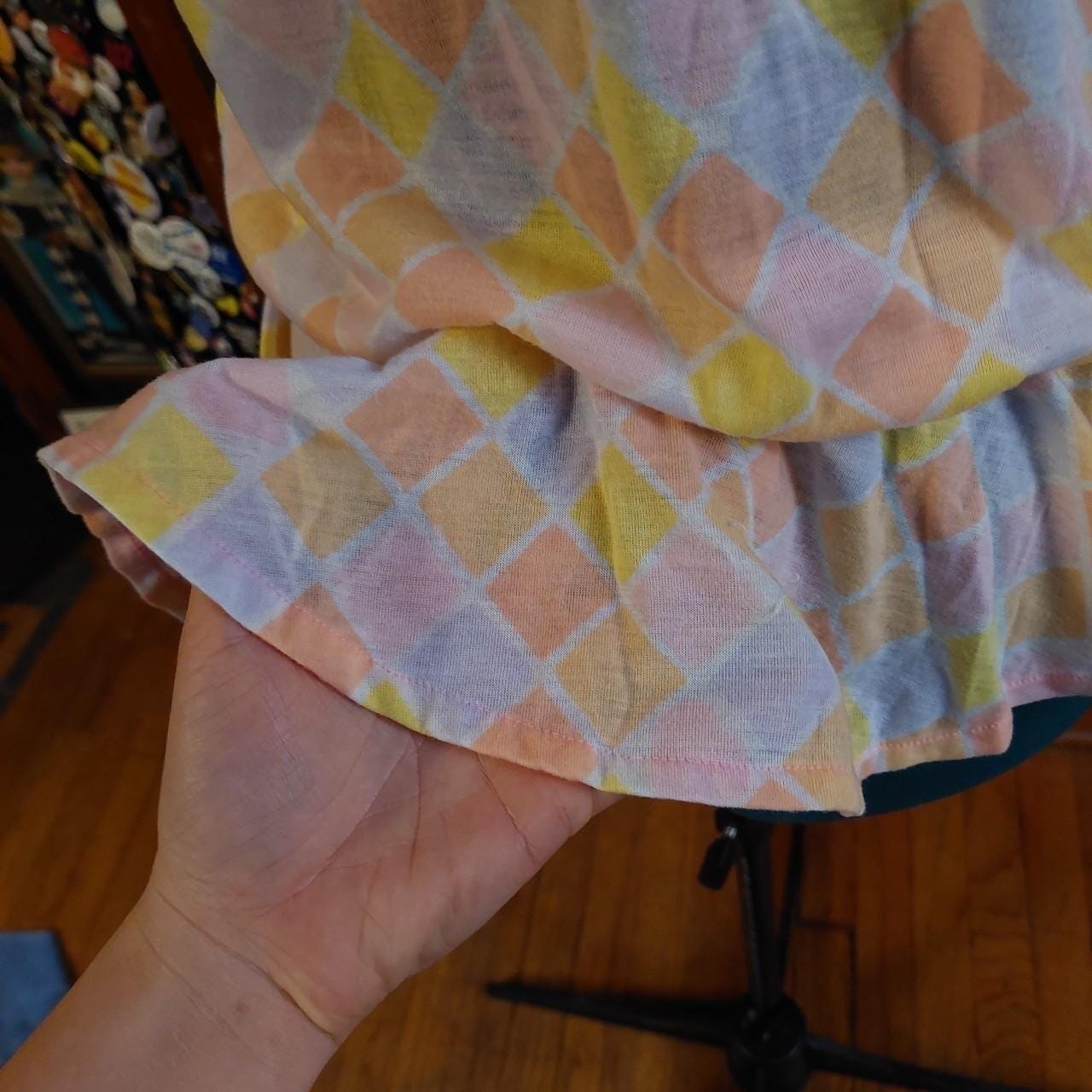 Vintagecpastel pink, purple, yellow, and orange diamond top with a ruffle hem.
