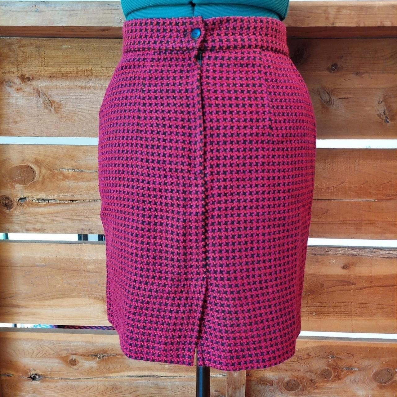 Vintage red, pink, and black houndstooth skirt with zipper and button closure.