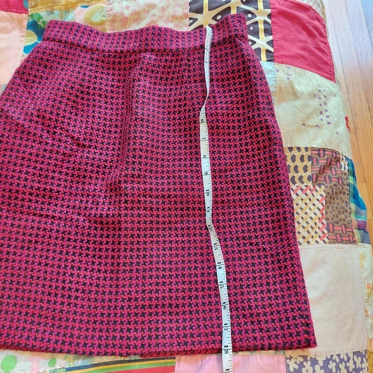 Vintage red, pink, and black houndstooth skirt with zipper and button closure.